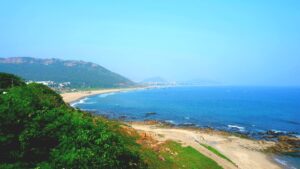 Scenic coastal view of Vizag beach and surrounding hills in one of the best locations to invest in Visakhapatnam