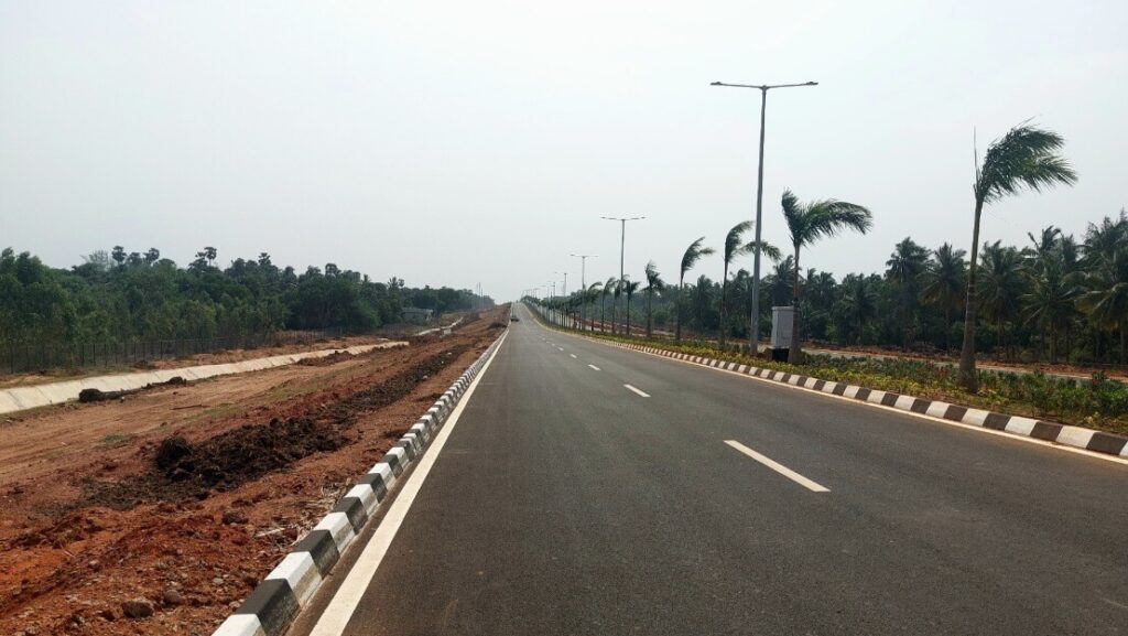 Modern road infrastructure near Bhogapuram driving Vizag real estate investment growth in 2026