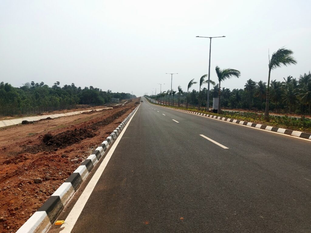 Modern road infrastructure near Bhogapuram driving Vizag real estate investment growth in 2026