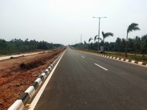 Modern road infrastructure near Bhogapuram driving Vizag real estate investment growth in 2026