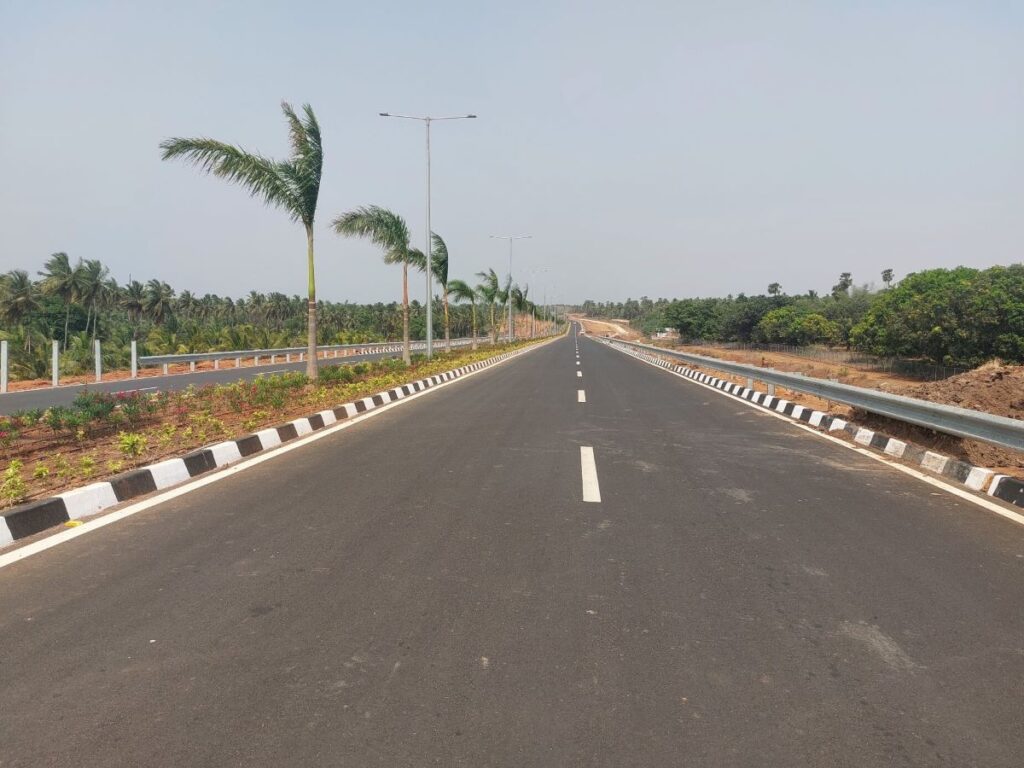 Approach road to Bhogapuram International Airport with landscaped median and street lighting