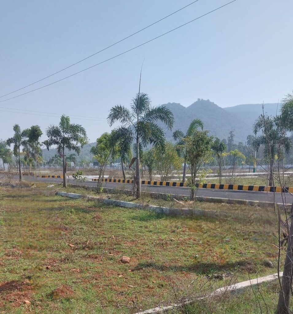 Scenic view of a VMRDA approved residential layout in Vizag with developed roads and open plots.